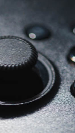 Vertical-Video-Close-Up-Of-Video-Game-Controller-Rotating-White-Background